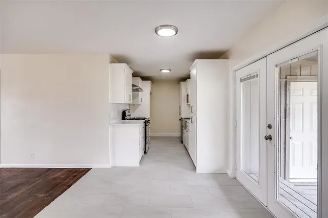 a view of a kitchen with a sink and a refrigerator