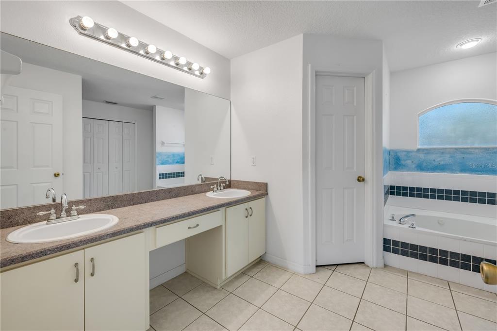 192 Azalea Road Edgewater, FL 32141 - Photo 21 of 94 a spacious bathroom with a sink and a mirror