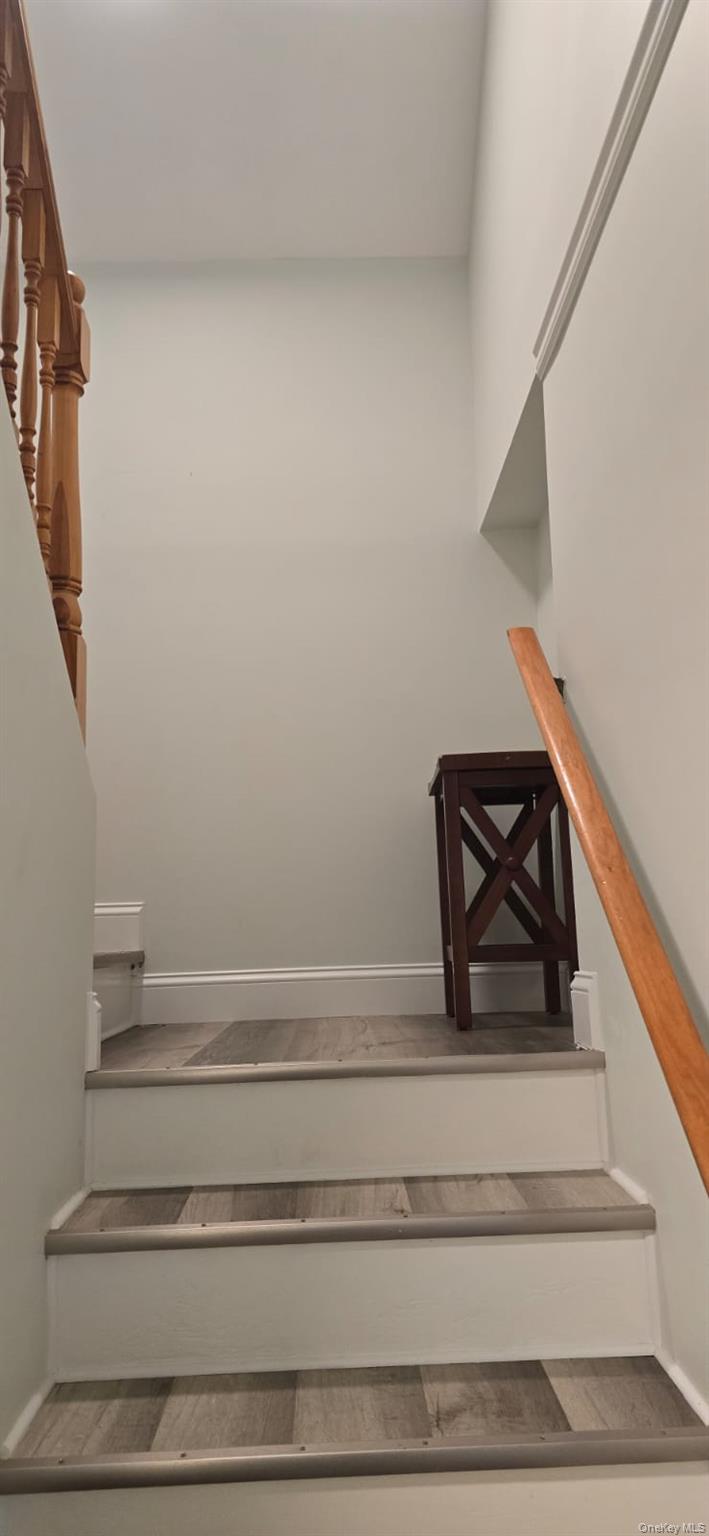 235 MacDougal Street Brooklyn, NY 11233 - Photo 12 of 21 Staircase with baseboards and wood finished floors