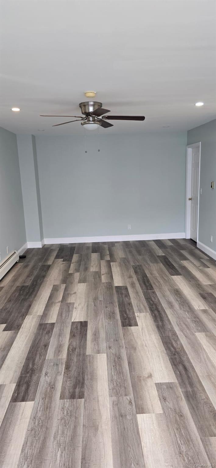235 MacDougal Street Brooklyn, NY 11233 - Photo 21 of 21 Unfurnished room featuring recessed lighting, light wood-type flooring, a baseboard heating unit, and ceiling fan