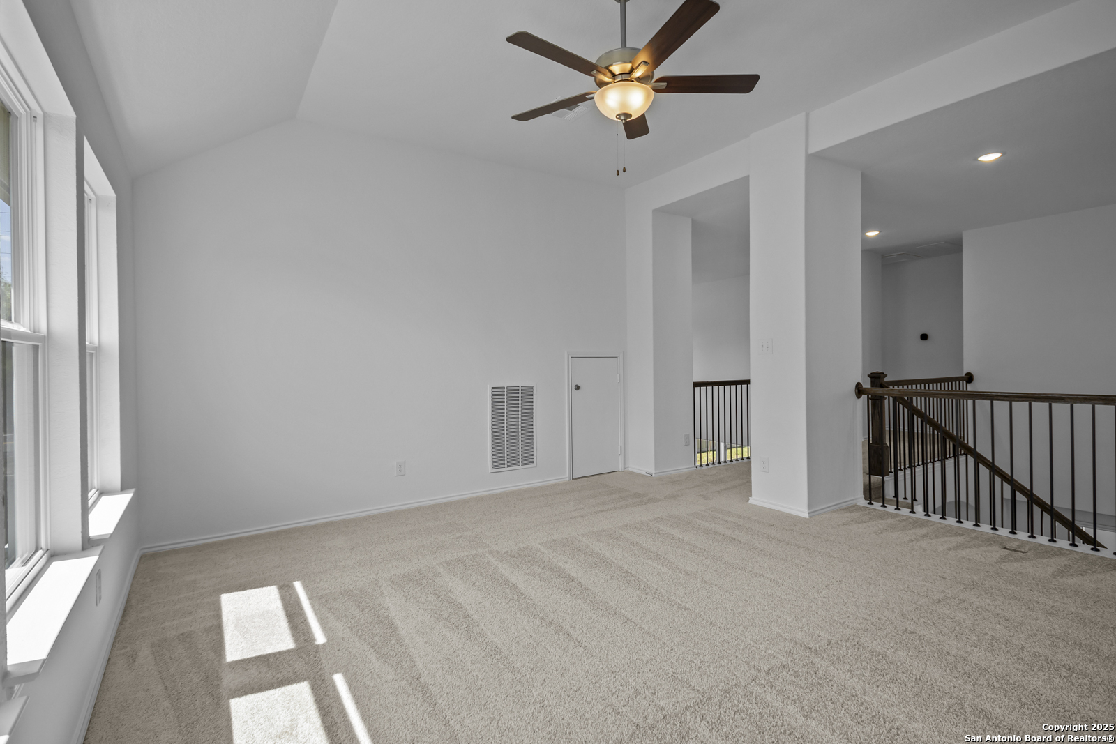 517 Foxtail Canyon Cibolo, TX 78108 - Photo 27 of 38 an empty room with windows and fan chandelier fan
