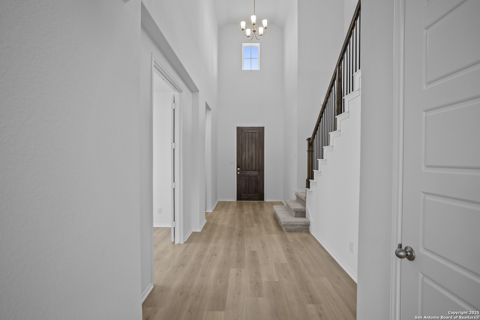 517 Foxtail Canyon Cibolo, TX 78108 - Photo 5 of 38 a view of a hallway with wooden floor and staircase