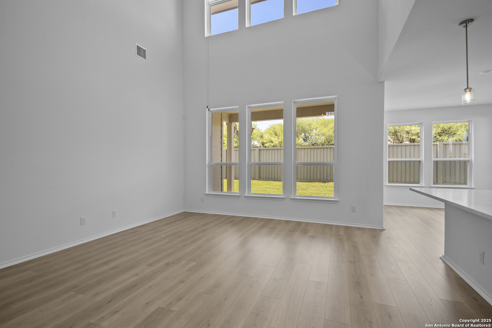 517 Foxtail Canyon Cibolo, TX 78108 - Photo 6 of 38 a view of an empty room with wooden floor and a window