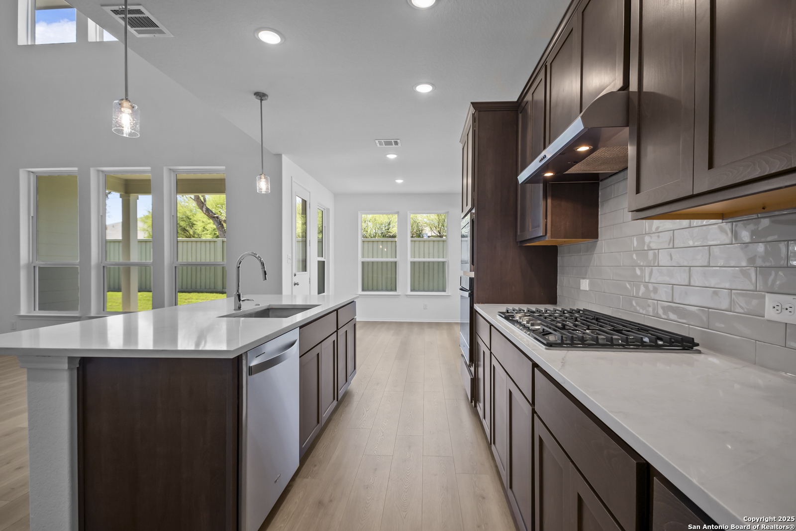 517 Foxtail Canyon Cibolo, TX 78108 - Photo 9 of 38 a kitchen with stainless steel appliances granite countertop a stove a sink and a refrigerator