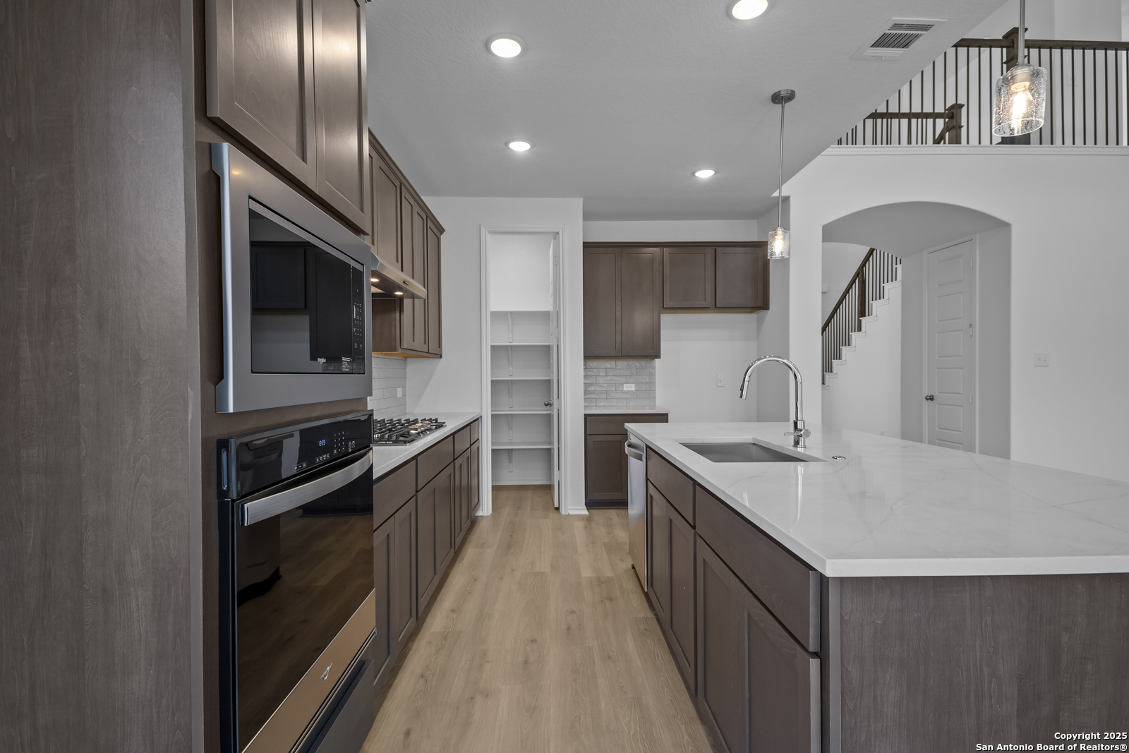 517 Foxtail Canyon Cibolo, TX 78108 - Photo 10 of 38 a kitchen with stainless steel appliances granite countertop a sink a stove and a refrigerator
