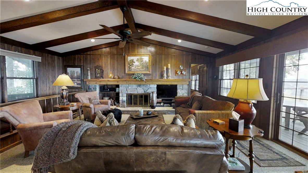 830 Pine Ridge Road Beech Mountain, NC 28604 - Photo 3 of 24 a living room with furniture and a fireplace