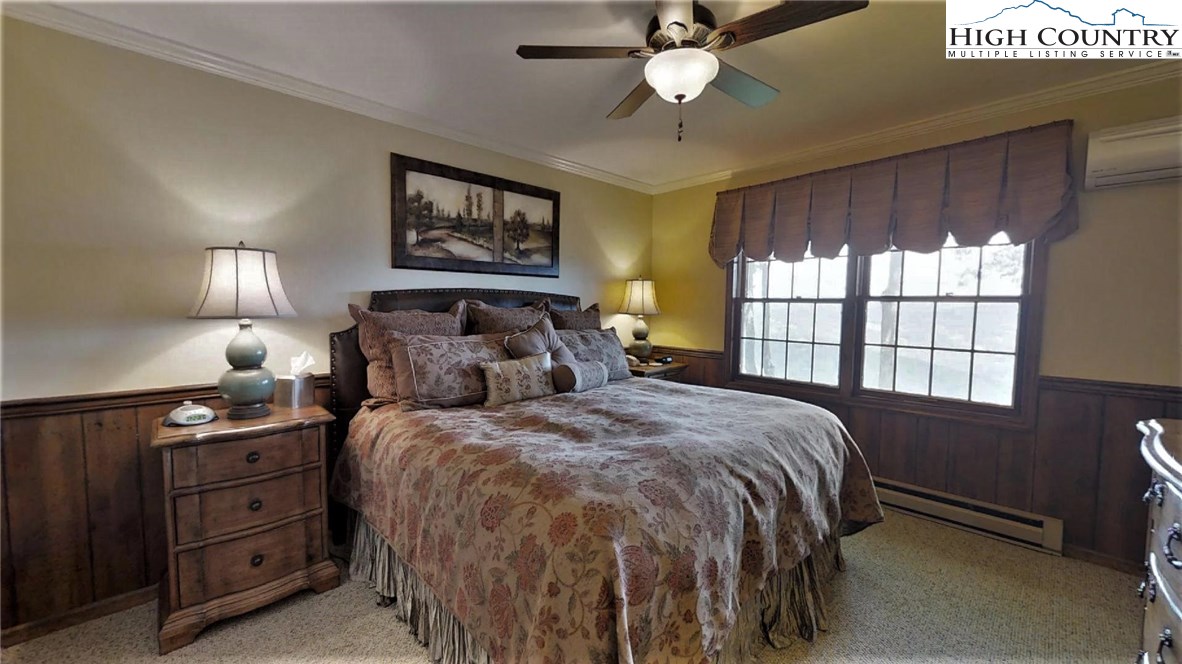 830 Pine Ridge Road Beech Mountain, NC 28604 - Photo 8 of 24 a bedroom with a bed and a window