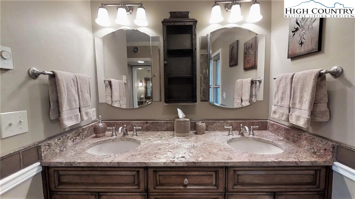 830 Pine Ridge Road Beech Mountain, NC 28604 - Photo 9 of 24 a bathroom with double vanity sinks and a mirror
