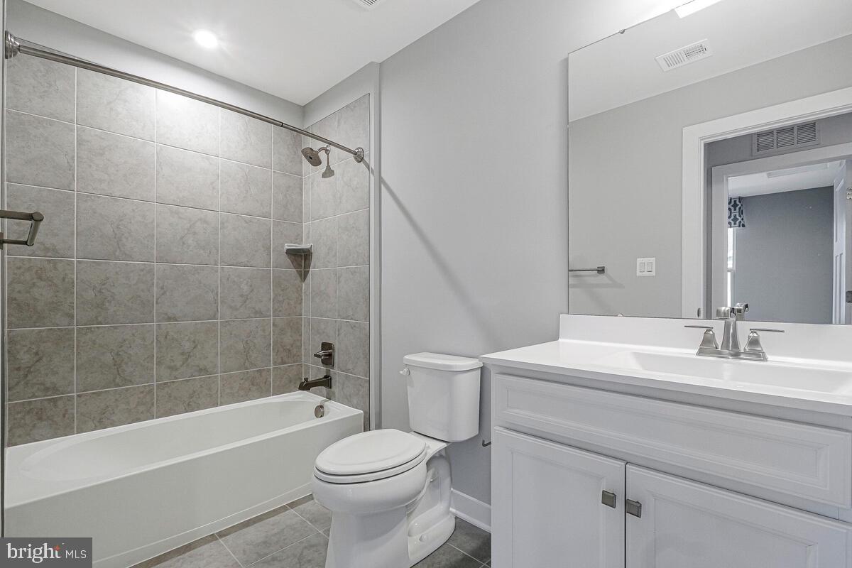 14380 Longhouse Loop Brandywine, MD 20613 - Photo 28 of 35 a bathroom with a sink a toilet and a bathtub