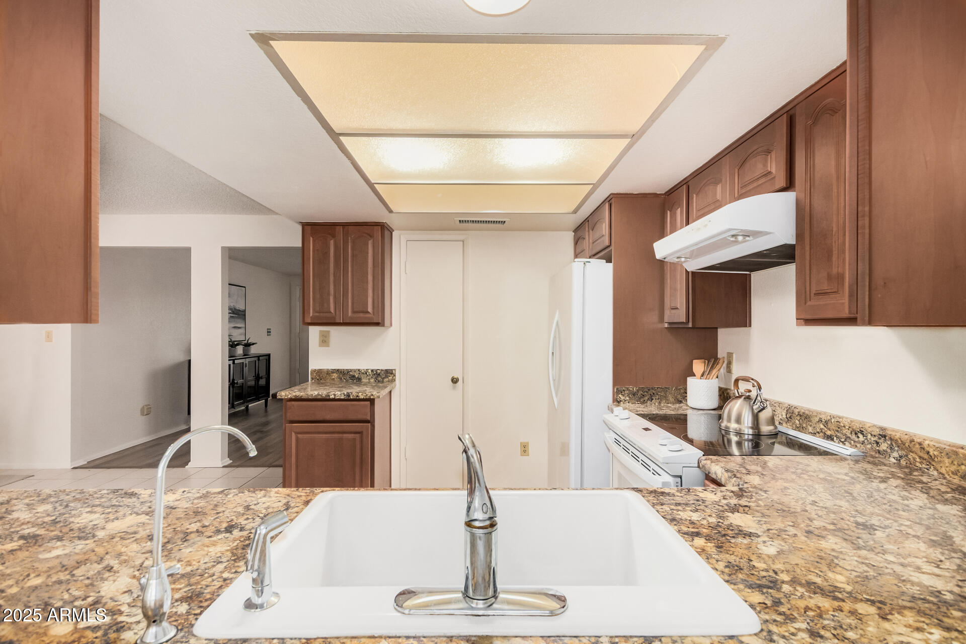 10512 West Ruth Avenue Peoria, AZ 85345 - Photo 11 of 33 a room with stainless steel appliances kitchen island granite countertop a sink and cabinets