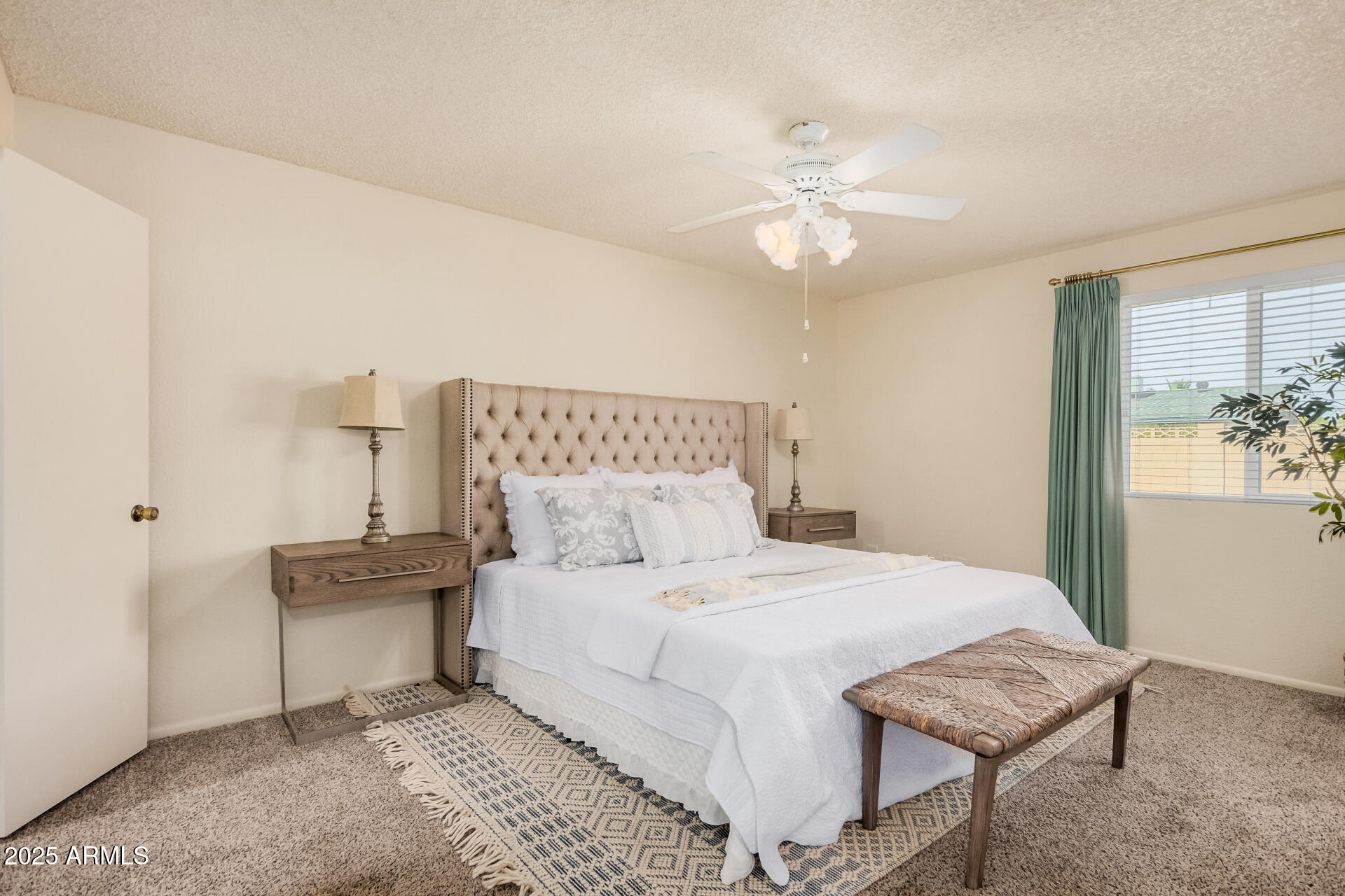10512 West Ruth Avenue Peoria, AZ 85345 - Photo 12 of 33 a bedroom with a bed and a chandelier