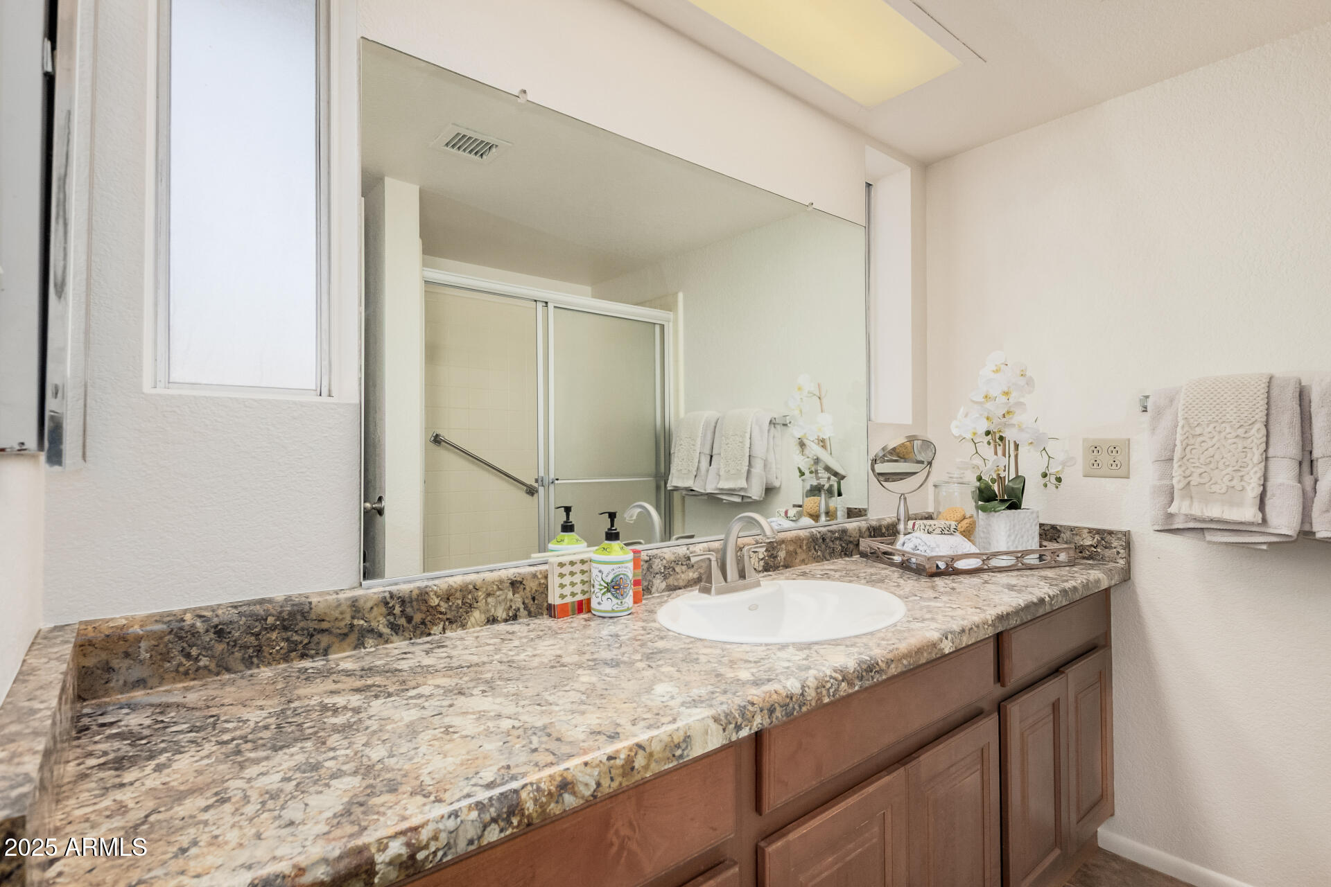 10512 West Ruth Avenue Peoria, AZ 85345 - Photo 15 of 33 a bathroom with a granite countertop sink and a mirror