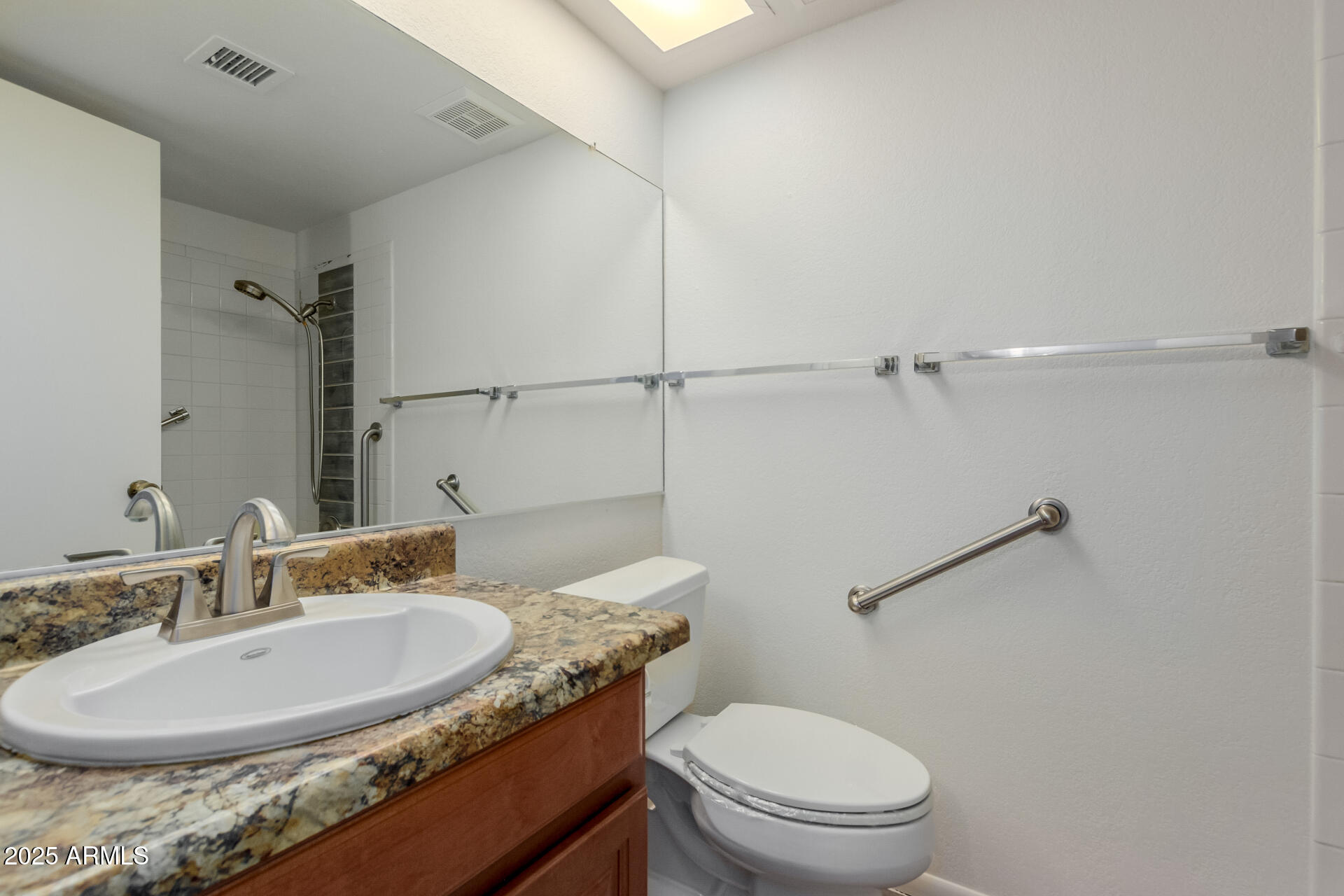 10512 West Ruth Avenue Peoria, AZ 85345 - Photo 22 of 33 a bathroom with a granite countertop sink a toilet and a mirror