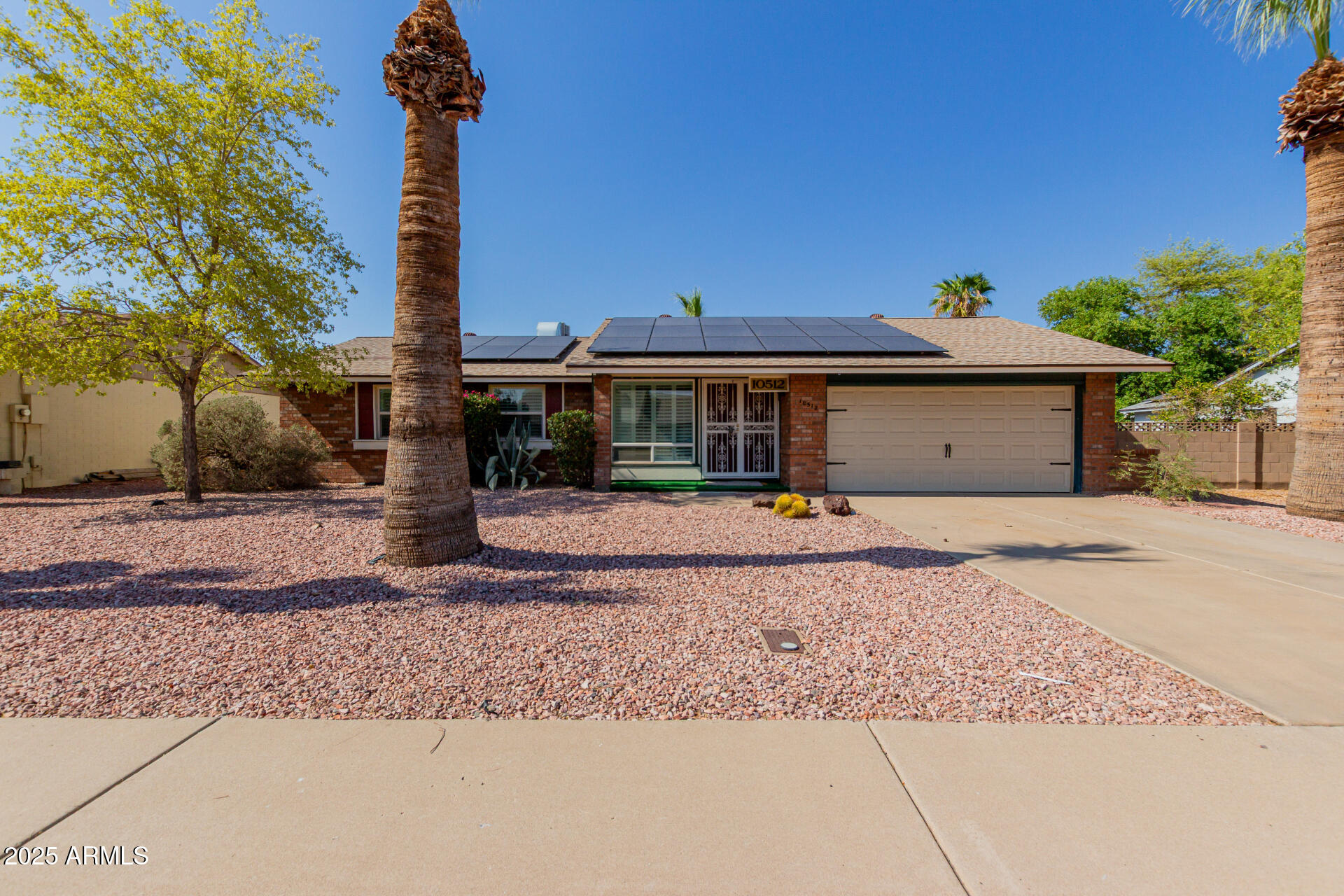 10512 West Ruth Avenue Peoria, AZ 85345 - Photo 31 of 33 a front view of a house with a yard and trees