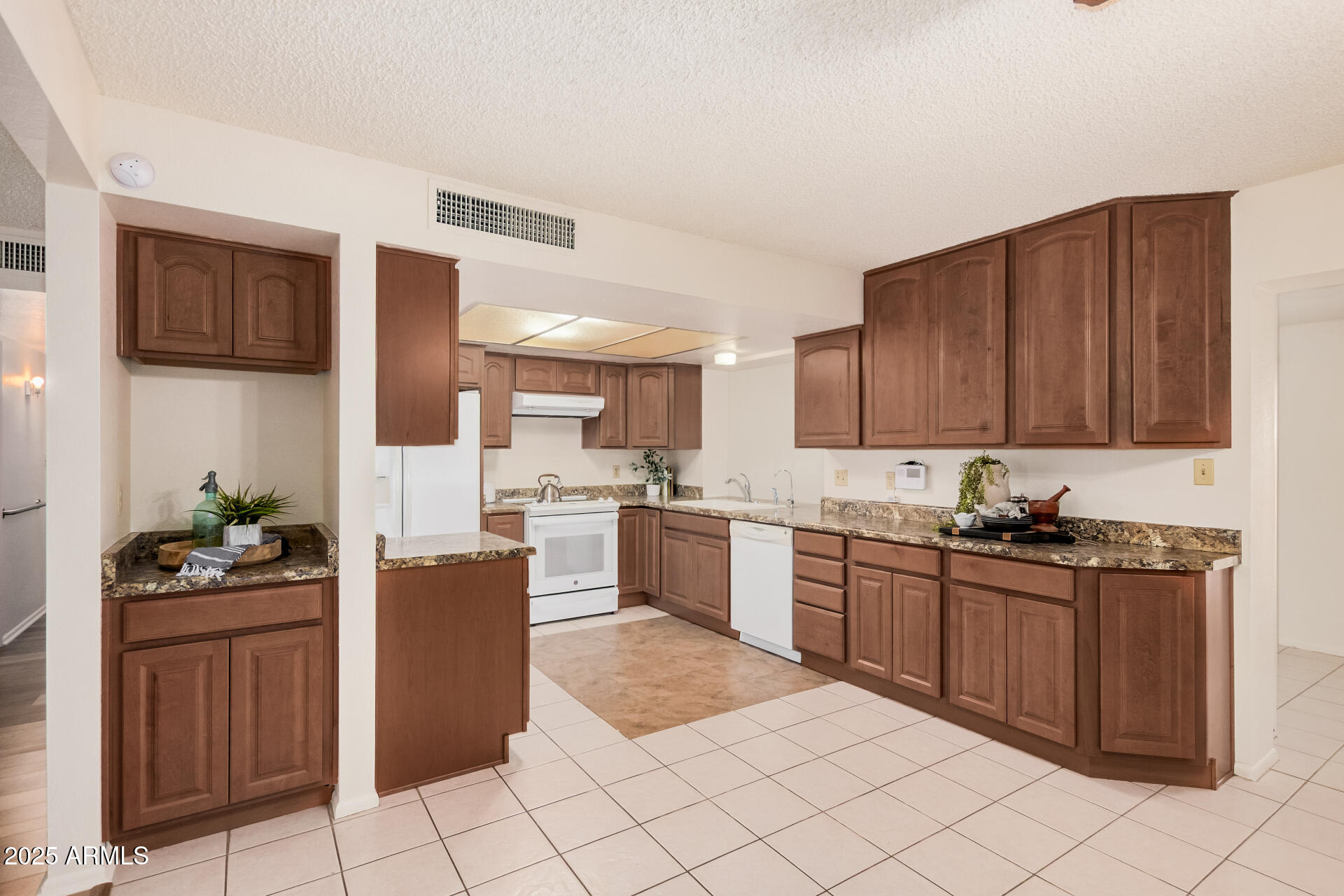 10512 West Ruth Avenue Peoria, AZ 85345 - Photo 8 of 33 a kitchen with granite countertop cabinets and steel stainless steel appliances