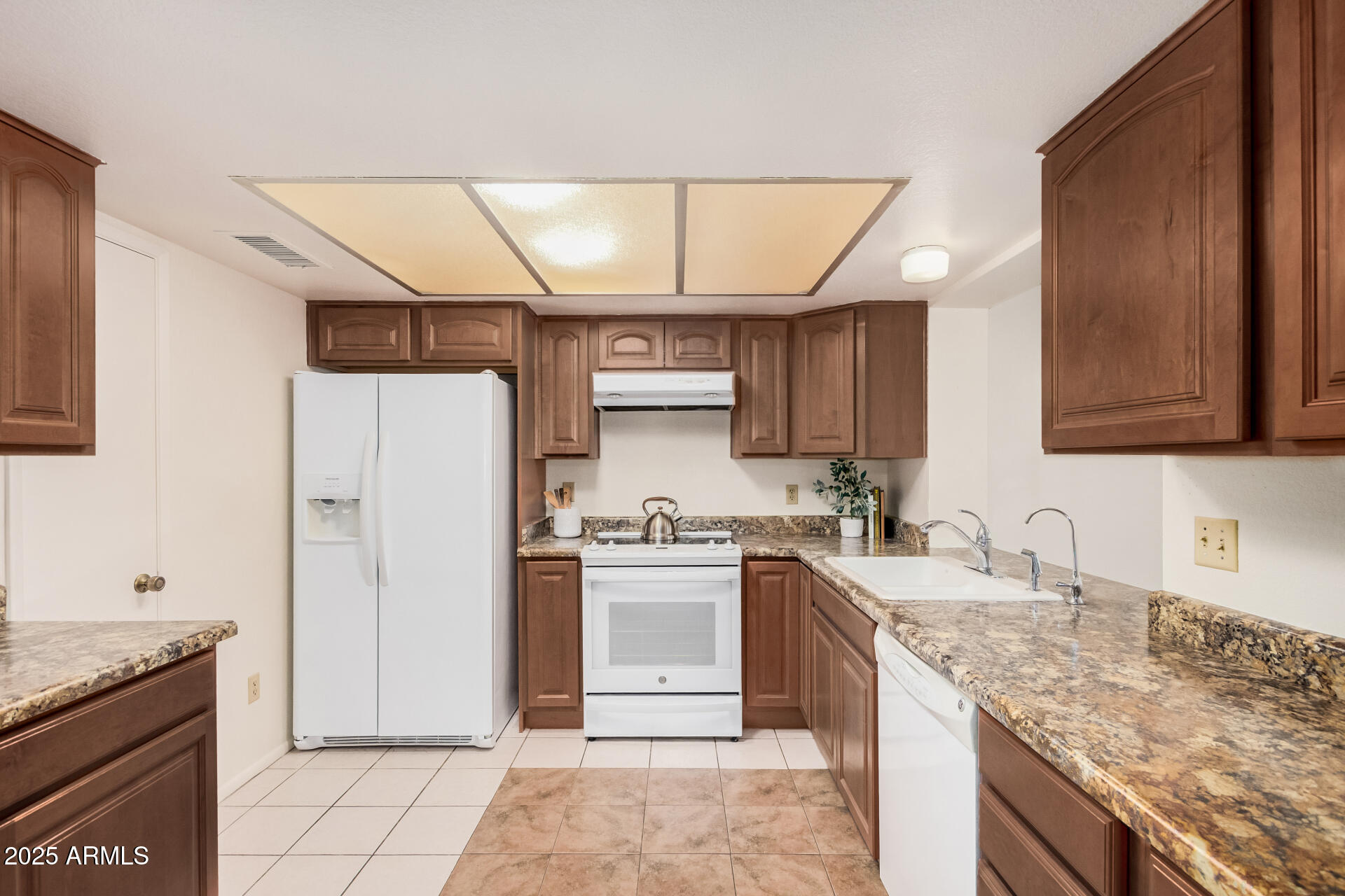 10512 West Ruth Avenue Peoria, AZ 85345 - Photo 9 of 33 a kitchen with a sink stove and refrigerator