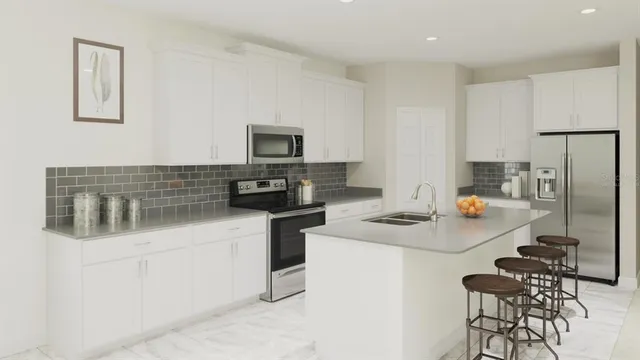 a kitchen with stainless steel appliances a stove a sink refrigerator and a stove