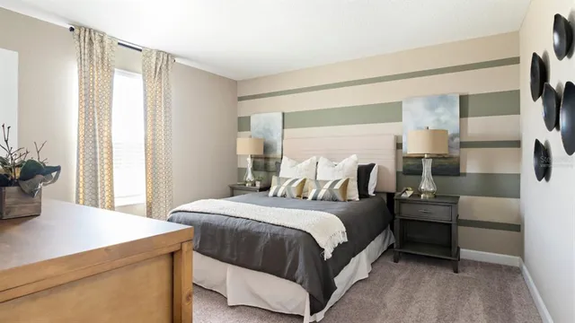 a bedroom with a bed and a potted plant