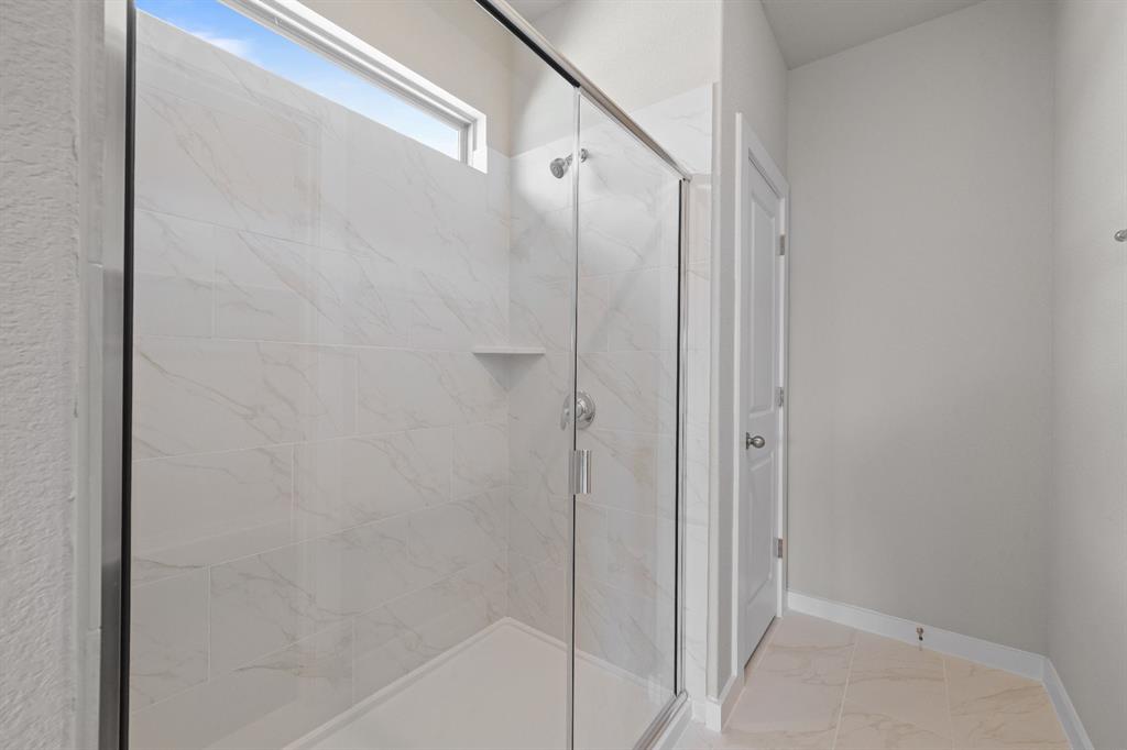 177 Sleep Hollow Jarrell, TX 76537 - Photo 17 of 24 Modern shower enclosure with clear glass paneling and chrome hardware
