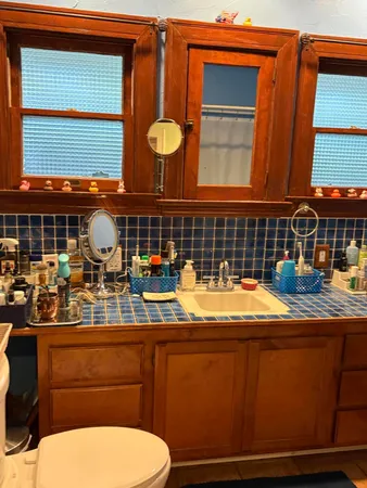 a bathroom with a sink a toilet and mirror