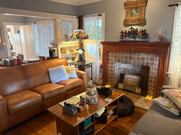 a living room with furniture and a fireplace