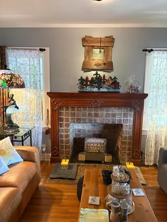 a living room with furniture a chandelier and a dining table