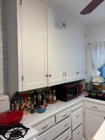a kitchen with a stove and a white cabinets