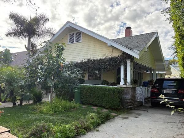 a view of a house with a yard and sitting area