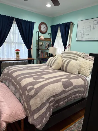 a bedroom with a bed and a large mirror