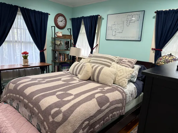 a bedroom with bed and a flat tv screen