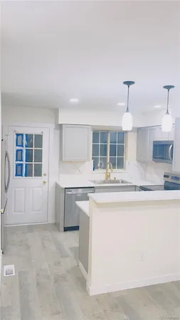 a kitchen with stainless steel appliances granite countertop a sink and a stove
