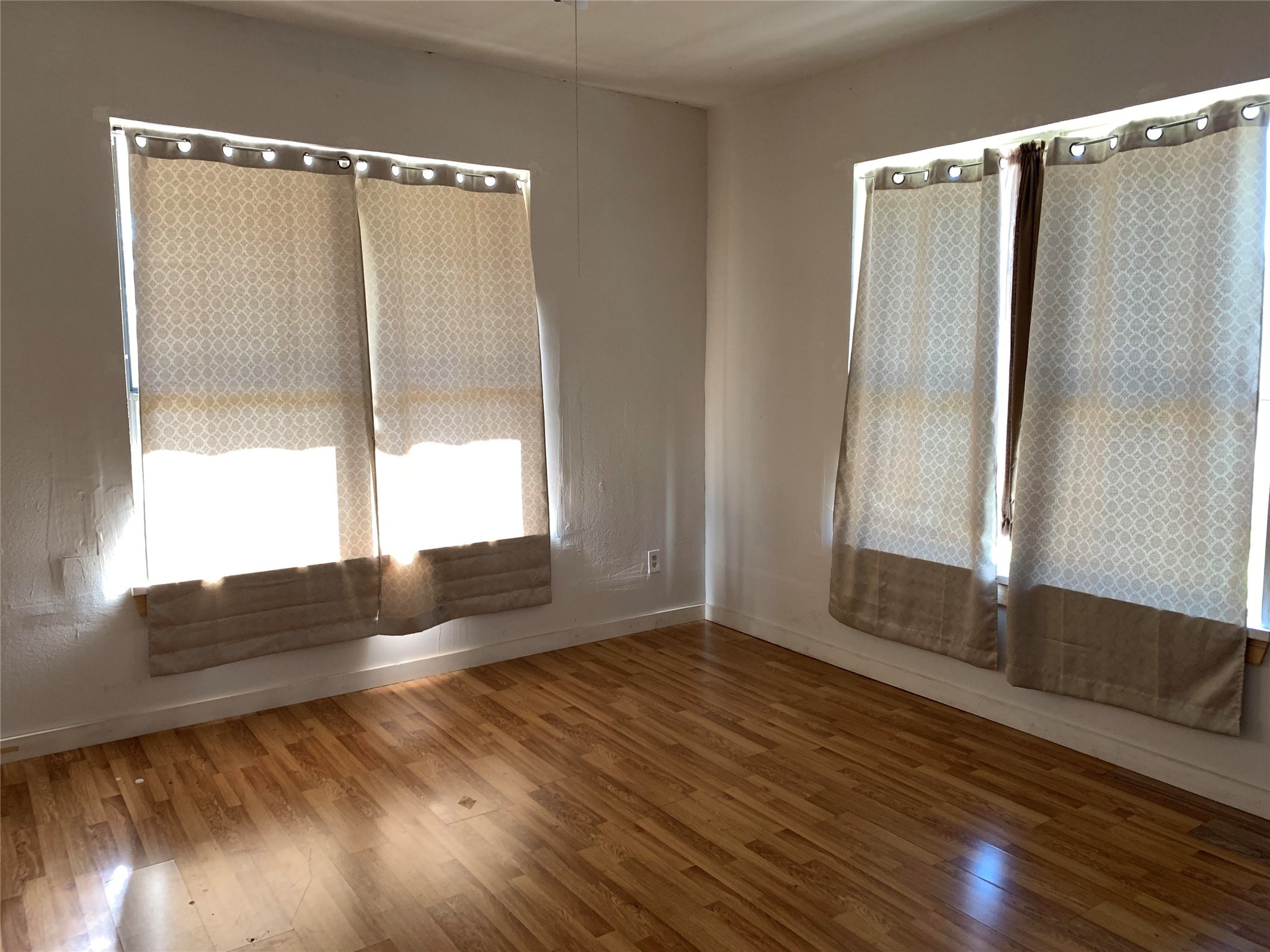206 Cosmos Street Houston, TX 77009 - Photo 4 of 14 a view of an empty room with wooden floor and a window