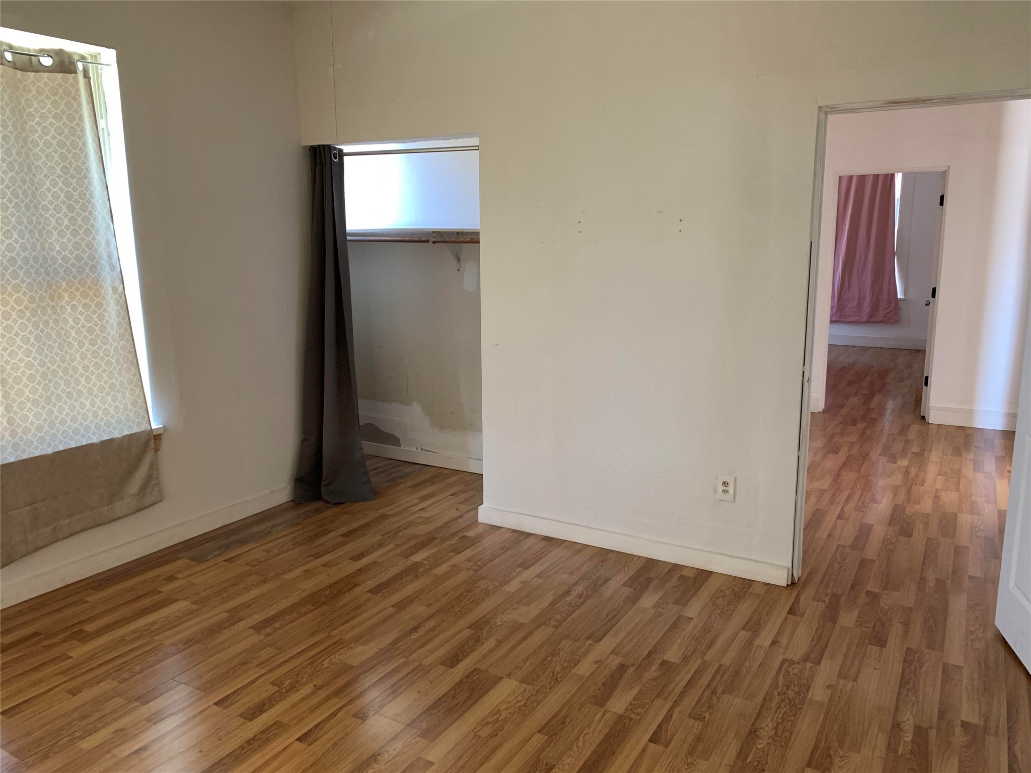 206 Cosmos Street Houston, TX 77009 - Photo 5 of 14 a view of an empty room with wooden floor and a window