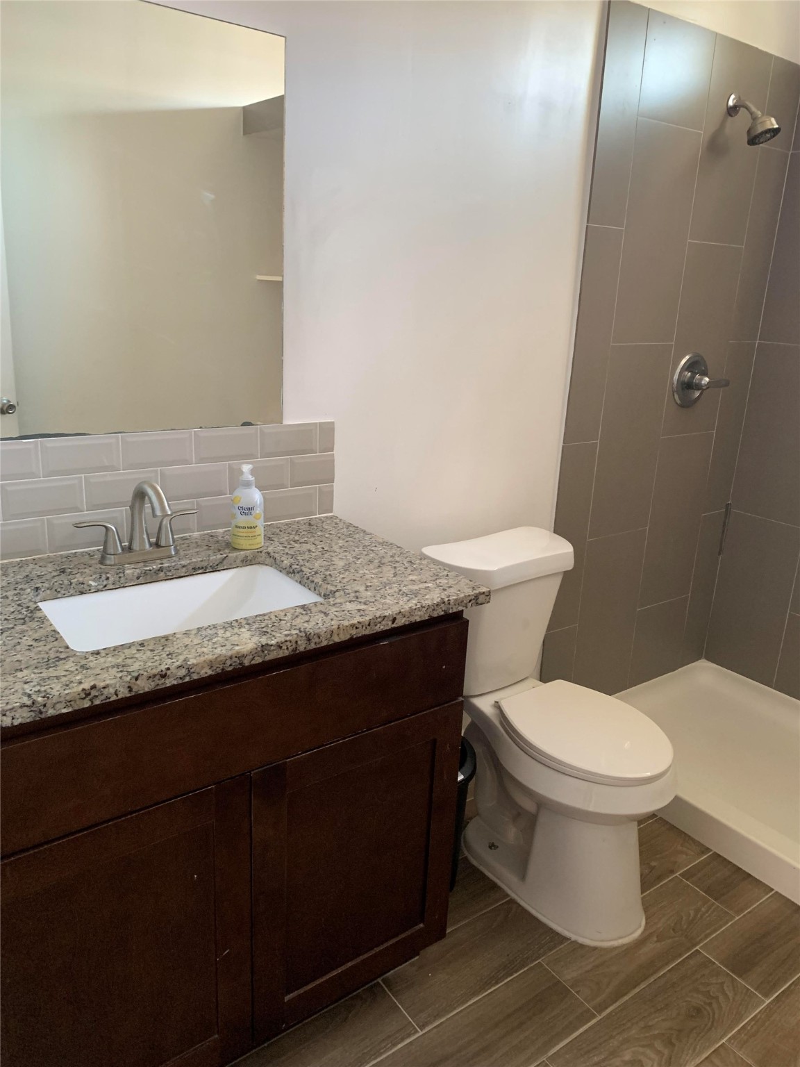 206 Cosmos Street Houston, TX 77009 - Photo 7 of 14 a bathroom with a granite countertop toilet sink and mirror