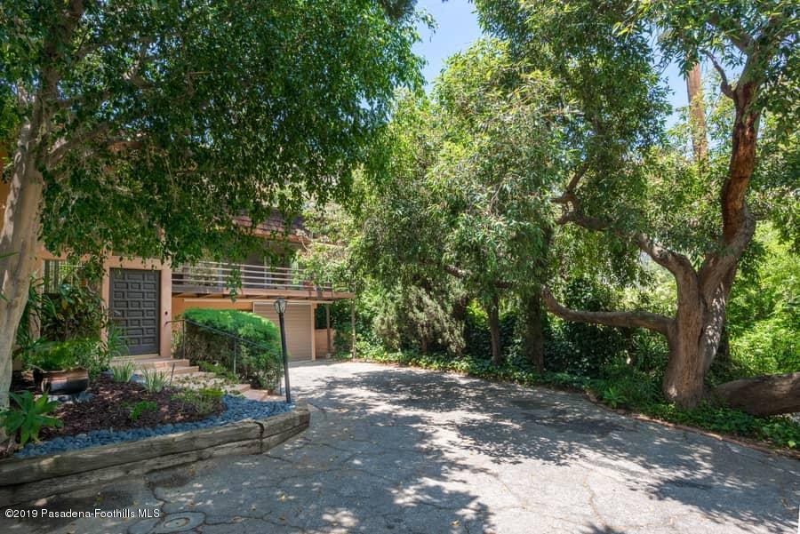 2107 Pinecrest Drive Altadena, CA 91001 - Photo 19 of 37 a view of a backyard with plants and large trees