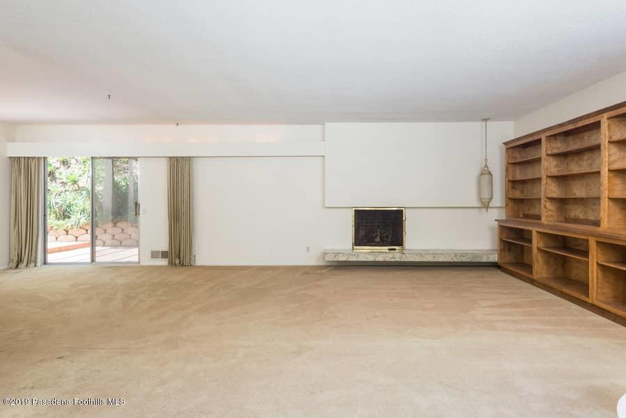 2107 Pinecrest Drive Altadena, CA 91001 - Photo 10 of 37 a view of an empty room with a fireplace and a window