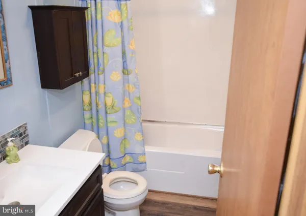 a bedroom with a bed and a curtain