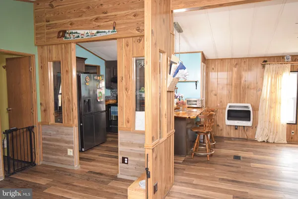 a view of kitchen with furniture and refrigerator