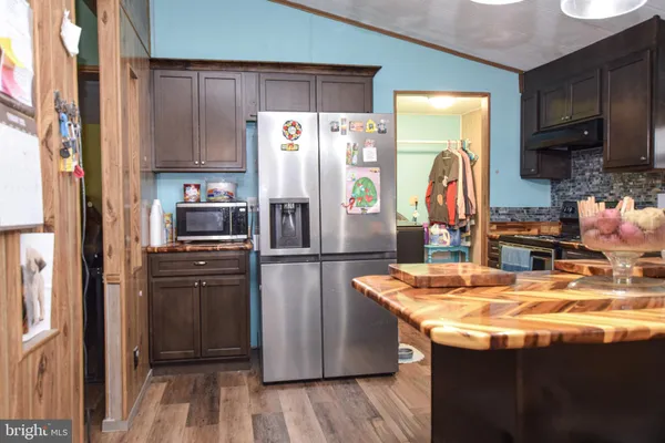 a kitchen with a stove and a refrigerator