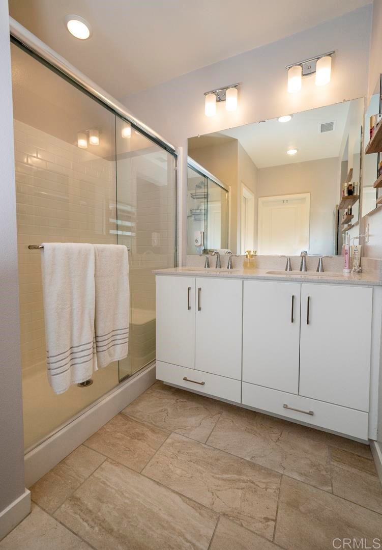 835 Blackstone Drive San Marcos, CA 92078 - Photo 13 of 30 a bathroom with a sink a mirror and a shower