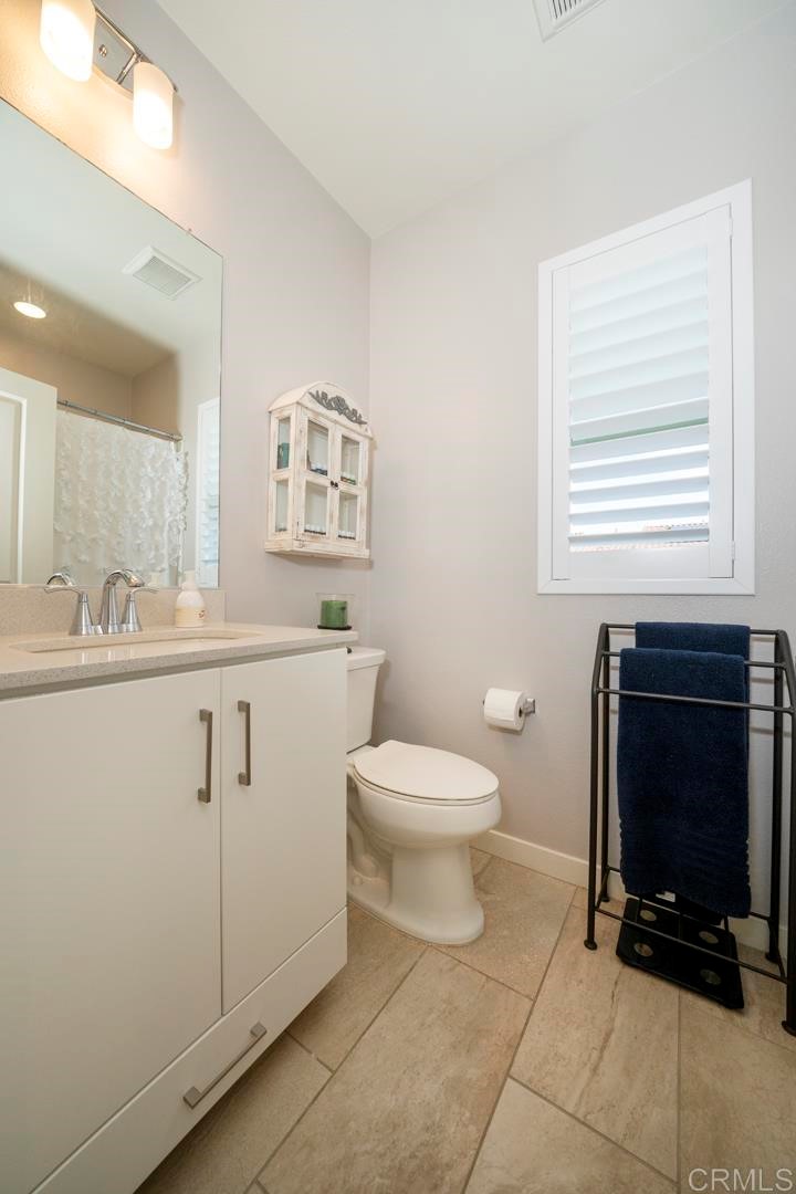 835 Blackstone Drive San Marcos, CA 92078 - Photo 18 of 30 a bathroom with a toilet a sink and a window