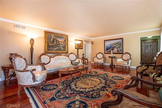 a bedroom with a bed wooden floor and window