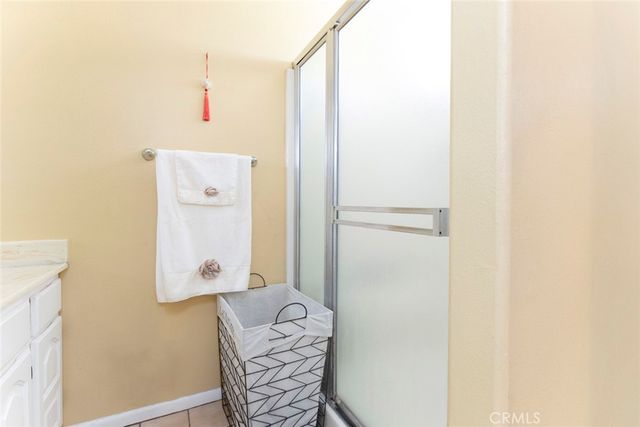 a bedroom with a bed mirror and window