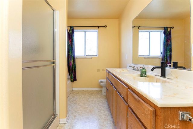 a view of a house with backyard and a tree