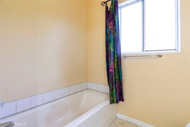 a front view of a house with a yard and mountain view