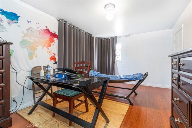 a front view of a house with a yard and mountain view