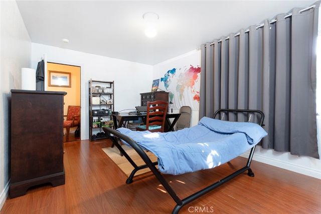 a view of a house with a yard and potted plants