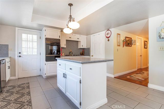 a view of a house with a yard and a tree
