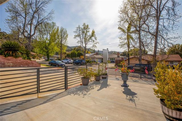 a front view of a house with plants