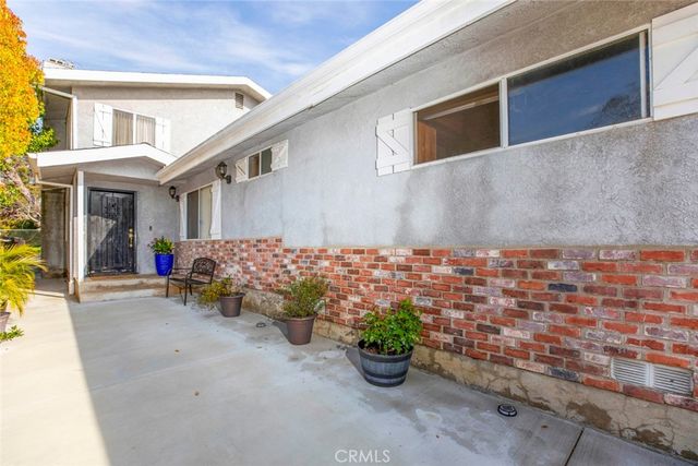 a living room with furniture a rug and a large window